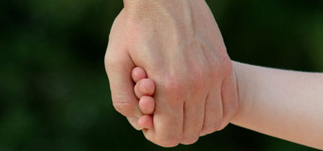 child holding adult's hand